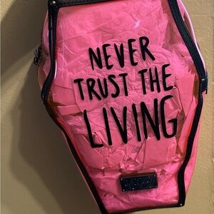 NEVER TRUST PINK CLEAR COFFIN BACKPACK